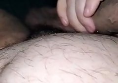 Stepmom in bed with her naked stepson giving him a handjob